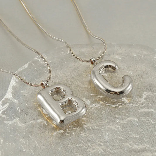 Collar Letra Globo Acero Inoxidable