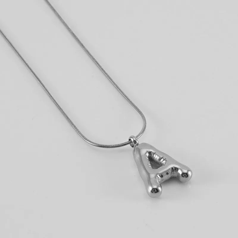 Collar Letra Globo Acero Inoxidable